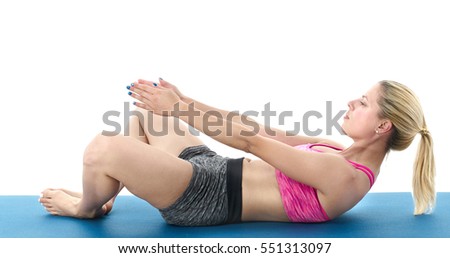 Woman making pilates mat exercises.