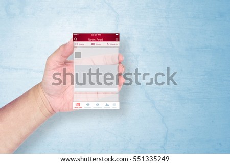 Hand holding a social network application template on grunge background.