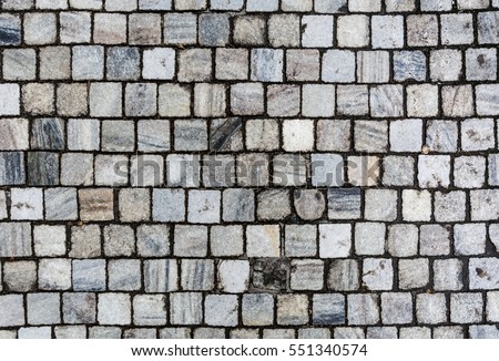 Stone pavement texture. Granite cobblestoned pavement background. Abstract background of old cobblestone pavement close-up. Seamless texture. Prague