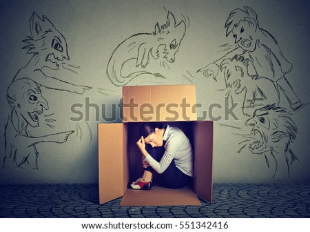 Bad evil men pointing at stressed woman. Desperate scared businesswoman hiding inside a box isolated on grey wall background. Negative human emotions face expression feelings life perception Royalty-Free Stock Photo #551342416