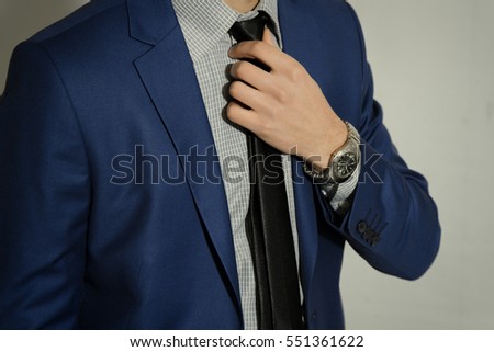 Businessman adjusting his tie - closeup shot