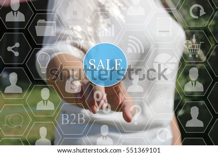 A businesswoman pushes a button SALE on the touch screen the web . The concept of online auctions, shopping, real estate .  
