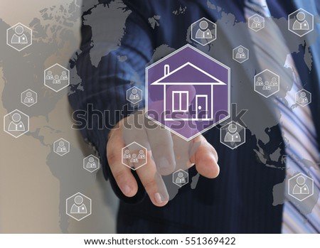 The businessman clicks with web touch home on the touch screen with maps of the world.The concept of finding housing for rent or purchase .