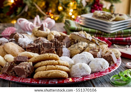 Close up of tray of homemade cookies and candy at holiday party in front of Christmas tree