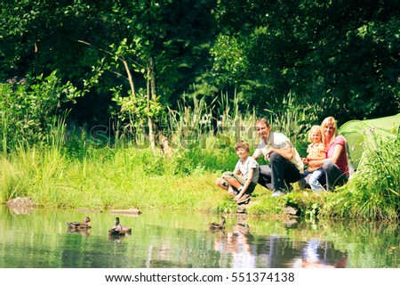 Family of Four having Fun Outdoors in the Summer