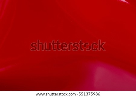 Close up of a red glossy leather texture. High resolution photo.