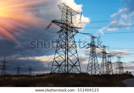  high-voltage  power lines at sunset. electricity distribution station. high voltage electric transmission tower.  Royalty-Free Stock Photo #551404123