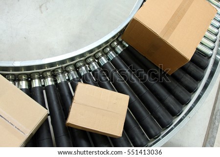 Boxes On Conveyor Belt Royalty-Free Stock Photo #551413036