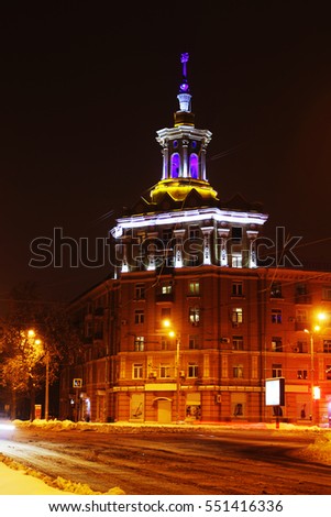 night photography tower with colored front lighting. Night photography with shutter speeds. Stalin empire building. Night road with lights.