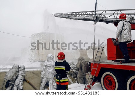 Firemen pouring flame with firefighting foam