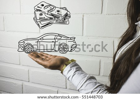 money and a car on a hand