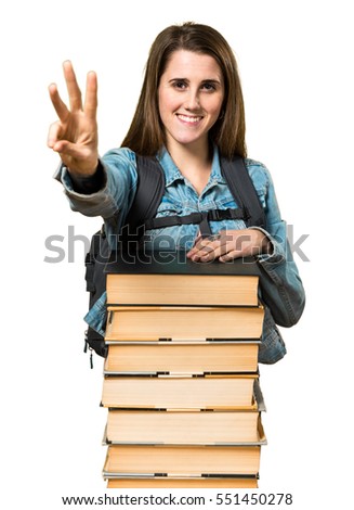 Teen student girl with a lot of books and counting three