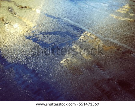 Closeup on natural wet car front window surface abstract background