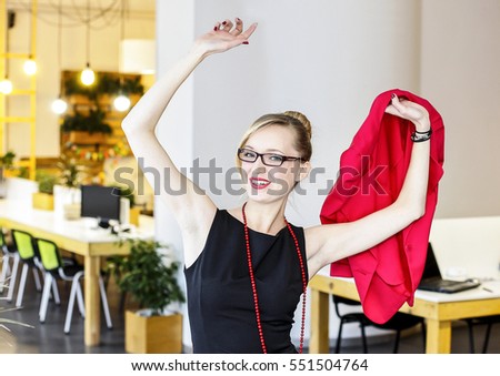 Attractive office girl lifts up her arms and rejoices