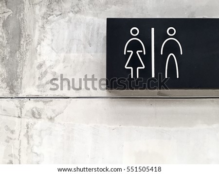 Signs bathroom on cement wall