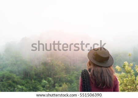 Women traveler with fog around forest