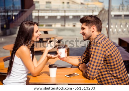 Young couple having date in cafe, drinking coffee  and talking Royalty-Free Stock Photo #551513233