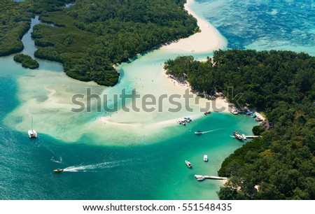 Aerial picture of Mauritius Island. Boat sailing around l'ile aux Cerfs in the beautiful lagoon of Mauritius