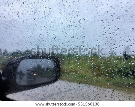 Car' window with rain drops