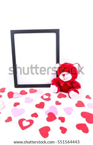 Valentine bear with a black picture frame and heart foreground isolated on a white background
