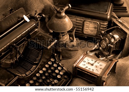 Vintage still life with old typewriter, retro camera and radio receiver in brown colors Royalty-Free Stock Photo #55156942