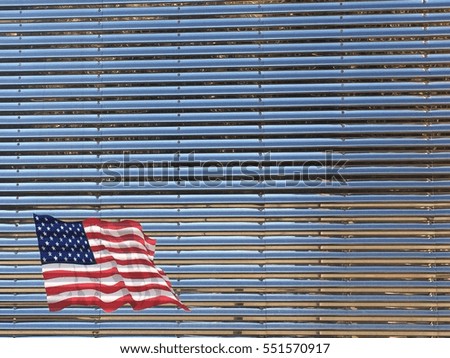 American flag on a shiny stainless steel wall.