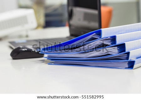 file folder with documents and documents. retention of contracts. With Notebook background  on white table in  meeting room 