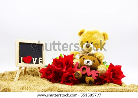 Two bears are sitting together with red roses are on white background, Idea for Love concept.