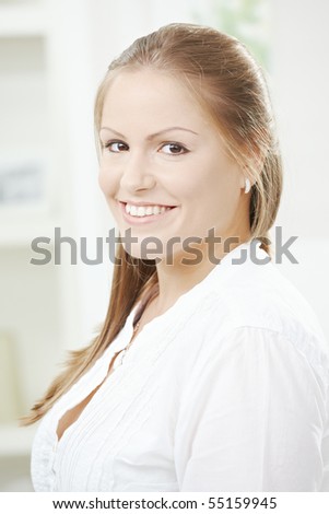 Portrait of happy attractive student girl smiling at home.