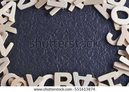 Various wooden alphabet on black background