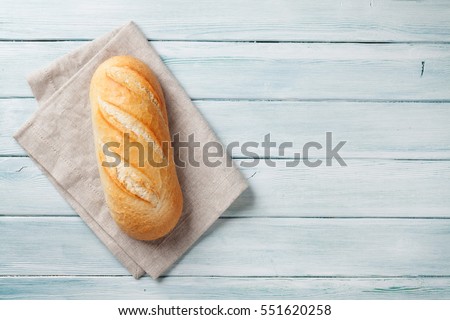 Fresh bread on wooden table. Top view with space for your text Royalty-Free Stock Photo #551620258