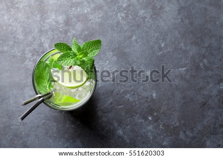 Mojito cocktail on dark stone table. Top view with space for your text  Royalty-Free Stock Photo #551620303
