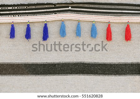 Grey thin striped wool plaid with blue and red fringe