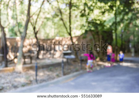 Blur image of mother and children in the zoo, use for background.