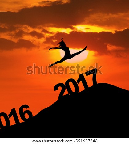 Image of an attractive woman is dancing on the hill above numbers 2017 at dusk time