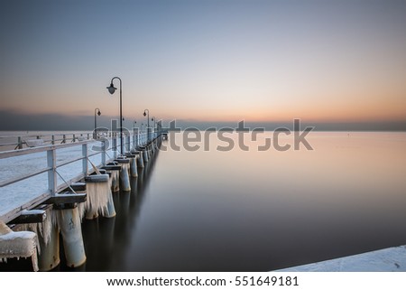 Beautiful sunrise at a frozen sea shore. Gdynia Poland