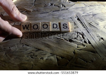 the word of WOODS on wood tiles concept and low light 
