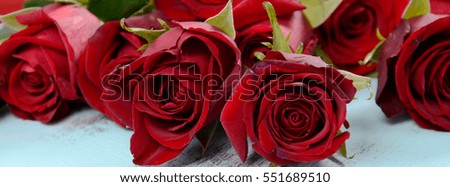 Beautiful Valentine red roses on pale blue shabby chic table, sized to fit a popular social media cover image placeholder.