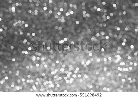 glitter vintage lights bokeh background. light silver and black. defocused. abstract