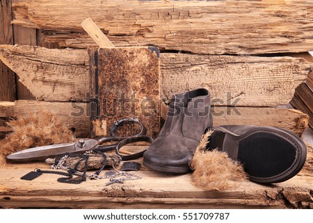 Handmade shoes and other objects on the old background