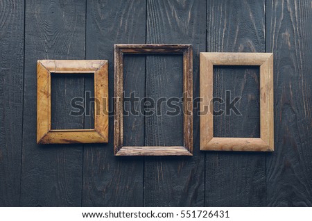 vintage frames on old wooden wall.