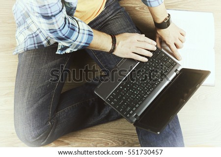 man on the floor with a laptop