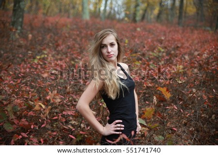 beautiful blonde girl posing and smiling at the camera in a haystack. Between plants pretty model, Slavonic woman, small breasts female wearing the black shirt, Walking in a park, close portrait
