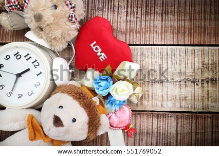 Valentine day decoration with brown bear and red heart shape with love text on wooden mock up ,Image for Happy Valentine holiday concept.