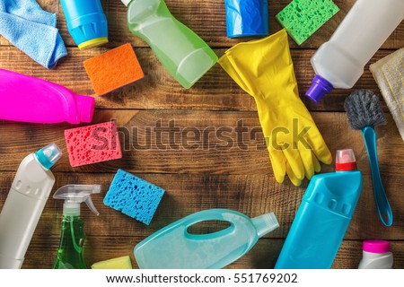 Frame of variety cleaning supplies on wooden table, top view Royalty-Free Stock Photo #551769202