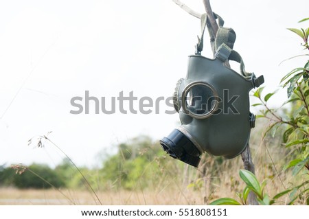 Gas mask on bush background