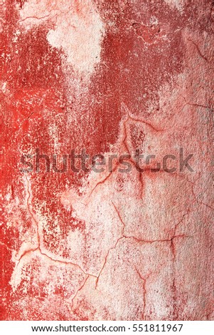 Grunge background with old stucco wall texture of beige color and cracked paint of red color