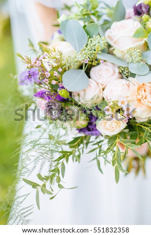 summer wedding bouquet in hands of the bride