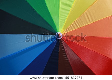 Umbrella with a rainbow pattern and colour 