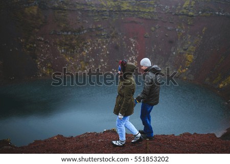 walking couple at volcano lake in Iceland